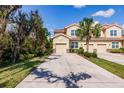 Inviting townhome with a private driveway, attached garage, and mature landscaping at 8256 Enclave Way # 101, Sarasota, FL 34243
