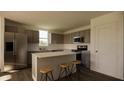 Modern kitchen with stainless steel appliances and an island at 13028 Cedar Elm Lane, Parrish, FL 34219