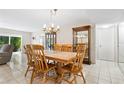 Charming dining area with wooden table and chandelier at 1717 Pelican Cove Rd # 334, Sarasota, FL 34231