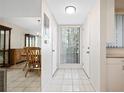 Bright and airy condo entryway with tiled floor and mirrored wall at 1717 Pelican Cove Rd # 334, Sarasota, FL 34231