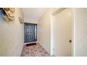 Interior entryway with a dark door and tiled floor at 3712 Hampshire Ln # 5623, Sarasota, FL 34232