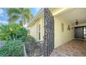 Ornate gate opens to a tiled entryway with a dark door at 3712 Hampshire Ln # 5623, Sarasota, FL 34232