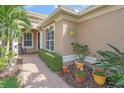 Front entryway with walkway and manicured landscaping at 6023 Wingspan Way, Bradenton, FL 34203