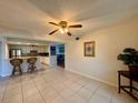 Bright kitchen features white cabinets, tile backsplash, and breakfast bar at 6447 Egret Ln # 413, Bradenton, FL 34210