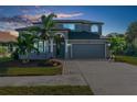 Charming two-story home with a well-maintained lawn, mature landscaping, and a welcoming front entrance at 1868 Scarlett Ave, North Port, FL 34289