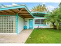 Mid-century modern home with teal accents and block glass at 2225 Valencia Dr, Sarasota, FL 34239