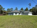 Single-story home boasts a spacious lawn, well maintained landscaping and a large driveway at 3006 Chickasaw Ave, North Port, FL 34288