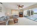 Bright living room with water view, comfy seating, and sliding glass doors to balcony at 4795 Independence Dr, Bradenton, FL 34210