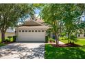 Two-story home with attached garage and landscaped yard at 6227 Blue Runner Ct, Lakewood Ranch, FL 34202