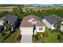 Single-story home with a tile roof, driveway, and view of neighboring houses at 6248 Champions Row, Bradenton, FL 34210
