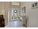 Bright and airy entryway with tile flooring and a decorative console table at 6248 Champions Row, Bradenton, FL 34210