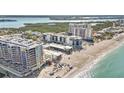 Stunning aerial view showcasing beachfront condo living, a sandy beach, and ocean waters at 1102 Benjamin Franklin Dr # 409, Sarasota, FL 34236