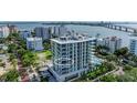 Aerial view of a modern high-rise building near the water at 111 Golden Gate Pt # 402, Sarasota, FL 34236