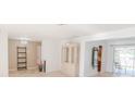 Open-concept living room features stylish built-in shelving, pool access, and natural light at 117 Hillcrest Dr, Bradenton, FL 34209