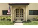 Building entrance with double doors and red tile roof at 1446 56Th W St # 1446, Bradenton, FL 34209