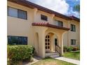 Building exterior with red tile roof and lush landscaping at 1446 56Th W St # 1446, Bradenton, FL 34209