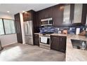 Modern kitchen with stainless steel appliances and granite countertops at 1508 Pelican Cove Rd # Gr233, Sarasota, FL 34231