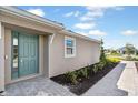 Home with a charming turquoise front door and meticulously landscaped walkway at 16112 Isola Pl, Bradenton, FL 34211
