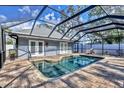 Inviting screened pool area with brick pavers and covered patio at 2110 Hawthorne St, Sarasota, FL 34239