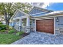 Attractive home exterior with a large wooden garage door at 2110 Hawthorne St, Sarasota, FL 34239
