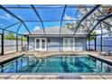 Screened-in pool with brick surround and tranquil setting at 2110 Hawthorne St, Sarasota, FL 34239