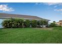 Large backyard with green grass and tropical plants at 3115 Live Oak Ln # 30, Palmetto, FL 34221