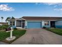 Front view of a light blue house with a two-car garage and a mailbox at 3115 Live Oak Ln # 30, Palmetto, FL 34221
