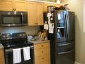 Kitchen features stainless steel appliances and light wood cabinets at 3820 Ironwood Ln # 106-I, Bradenton, FL 34209