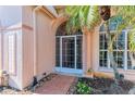 Inviting front entrance with a screened door and brick walkway at 4245 Hearthstone Dr, Sarasota, FL 34238