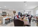 Open floor plan connecting kitchen and living room with a large dining table at 5058 Granite Dust Pl, Palmetto, FL 34221