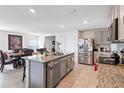 Island kitchen with granite countertops and stainless steel appliances at 5058 Granite Dust Pl, Palmetto, FL 34221