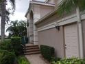 Side view of house with stairs and landscaping at 5242 Parisienne Pl # 201, Sarasota, FL 34238