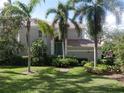 Two-story home with teal door and palm trees at 5242 Parisienne Pl # 201, Sarasota, FL 34238