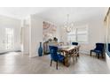 Elegant dining room featuring a wood table, blue velvet chairs, and a chandelier at 6546 Rosehill Farm Run, Lakewood Ranch, FL 34211