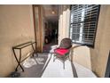Welcoming front entry with sitting area and glass-top side table at 8115 Stirling Falls Cir, Sarasota, FL 34243