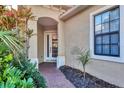 Inviting front entry with a charming door and lush landscaping at 11414 Hawick Pl, Lakewood Ranch, FL 34202