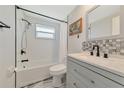 Renovated bathroom with bathtub and gray vanity at 138 Paddington Rd, Venice, FL 34293