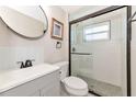 Updated bathroom with gray vanity and walk-in shower at 138 Paddington Rd, Venice, FL 34293