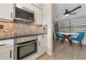 Modern kitchen with stainless steel appliances and mosaic backsplash at 138 Paddington Rd, Venice, FL 34293