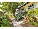 Exterior view showing stairs leading to condo and lush landscaping at 1519 Pelican Point Dr # 292, Sarasota, FL 34231