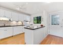 Bright kitchen with white cabinetry, stainless appliances, and granite countertops at 1519 Pelican Point Dr # 292, Sarasota, FL 34231