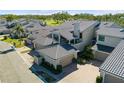 Aerial view of condo showcasing its tile roof and landscaping at 2155 Harbourside Dr # 804, Longboat Key, FL 34228