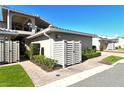 Charming exterior of home featuring a white fence, lush landscaping, and well-manicured lawn at 2155 Harbourside Dr # 804, Longboat Key, FL 34228