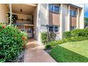 Inviting condo entrance with lush landscaping and walkway at 2724 Clubhouse Dr # 104, Sarasota, FL 34232