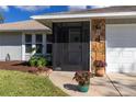 Charming home with a screened-in entryway, well maintained landscaping and a two-car garage at 6929 Arbor Oaks Cir, Bradenton, FL 34209