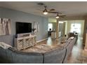 Spacious living room with a large sectional sofa and wall-mounted TV at 2271 50Th Street E Cir, Palmetto, FL 34221