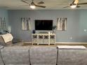 Living room featuring a sectional sofa, media console, and hardwood flooring at 2271 50Th Street E Cir, Palmetto, FL 34221