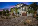 Stunning two-story home with a dark roof, and a well manicured front yard at 243 S Harbor Dr, Holmes Beach, FL 34217
