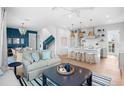 Open floor plan living room and kitchen with island and white cabinetry at 243 S Harbor Dr, Holmes Beach, FL 34217