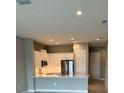 Modern kitchen featuring white cabinets, stainless steel appliances, and a breakfast bar at 24732 Buckingham Way, Port Charlotte, FL 33980